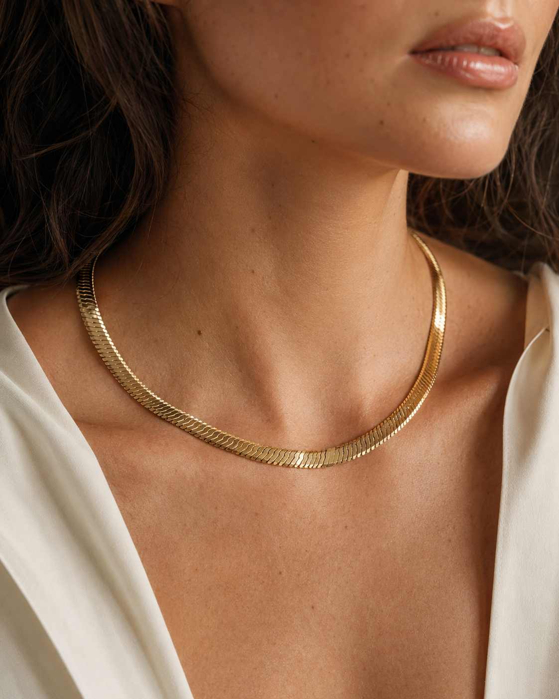 Model wearing a gold-tone herringbone necklace