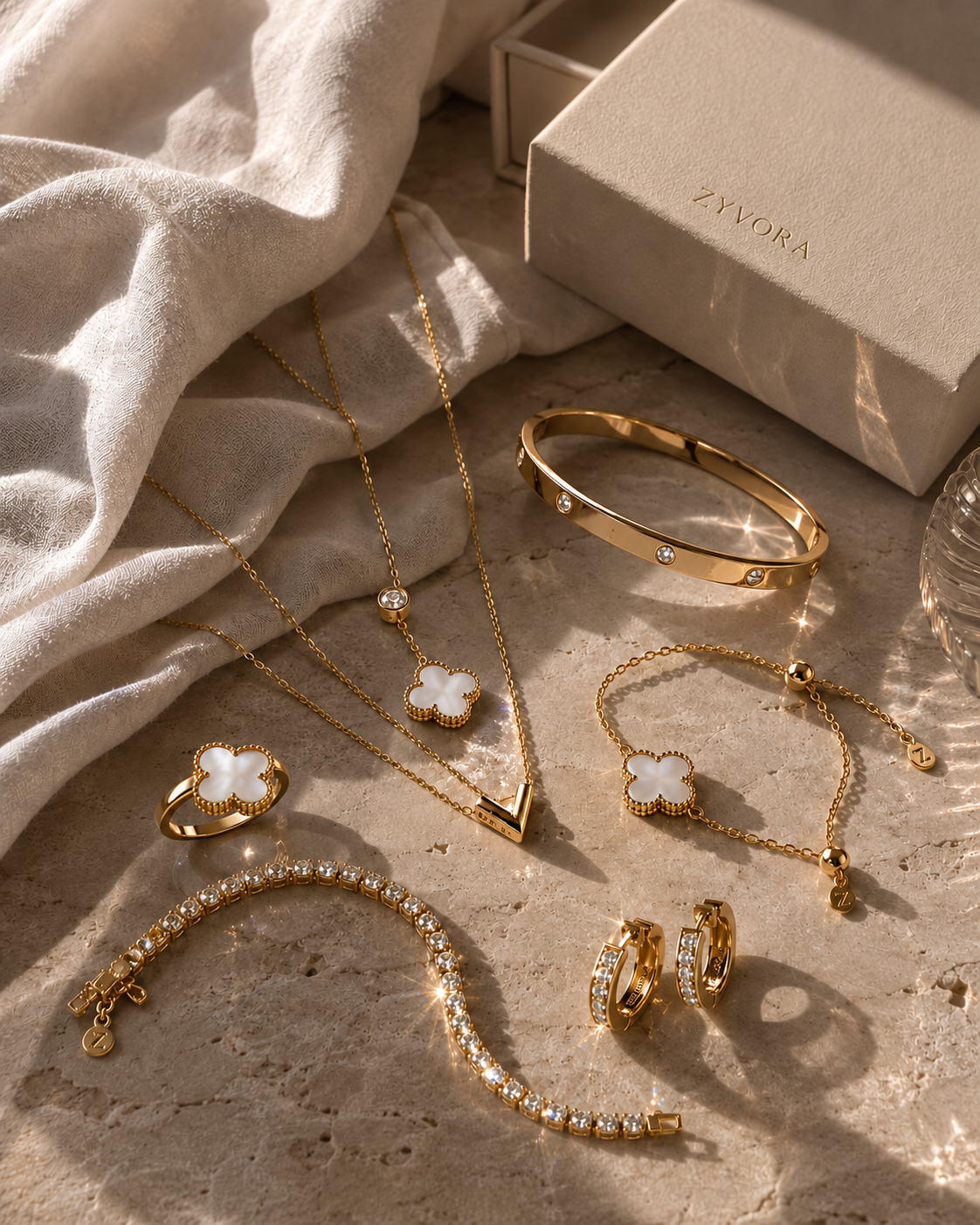 Gold-tone jewelry arranged beside a Zyvora Jewelry box