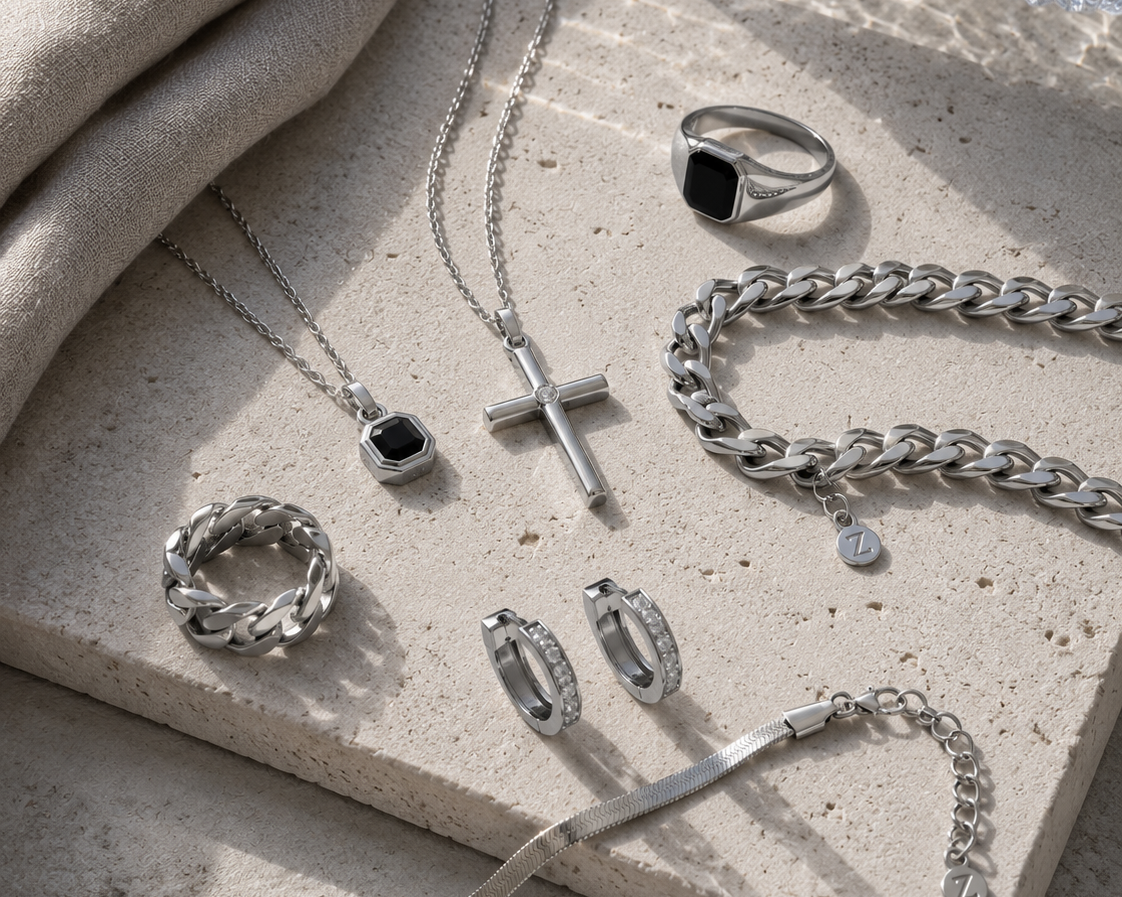 Silver-tone Zyvora jewelry arranged on warm stone