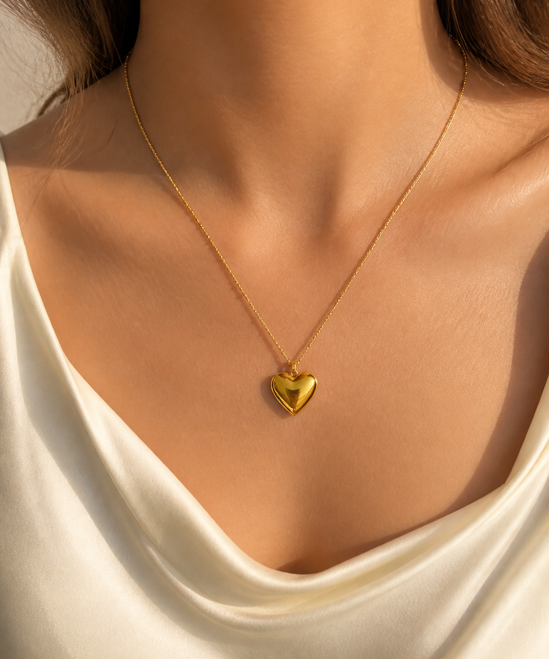 Model wearing Cora Heart Pendant in gold [finish:gold]