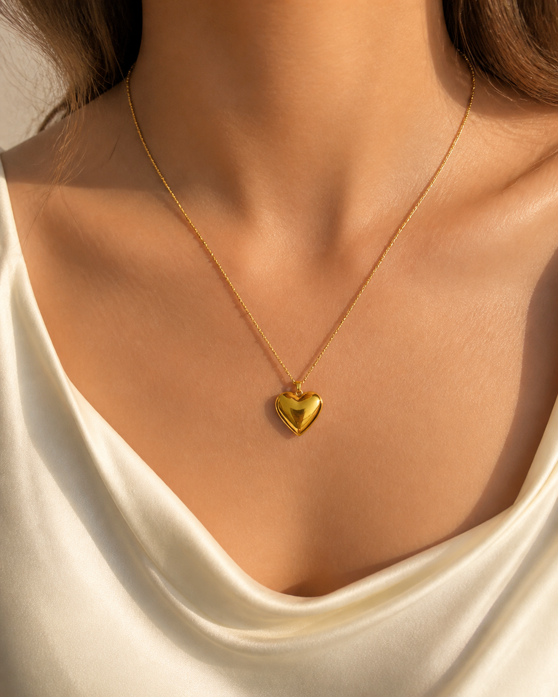 Model wearing Cora Heart Pendant in gold