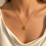 Model wearing Cora Heart Pendant in gold [finish:gold]