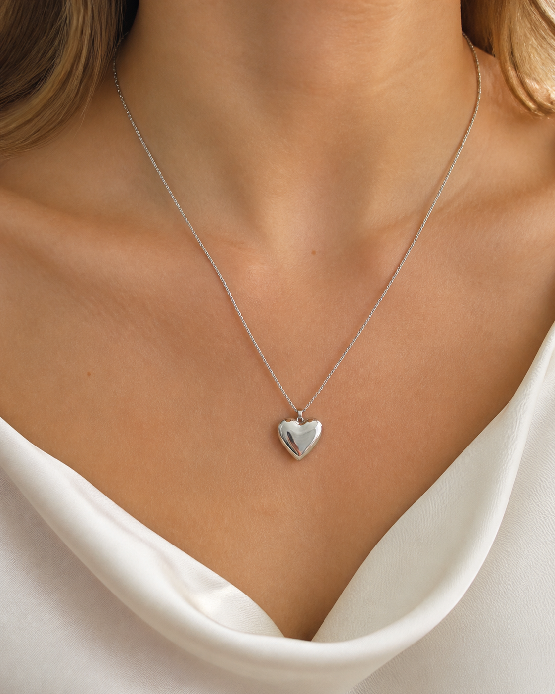 Model wearing Cora Heart Pendant in silver