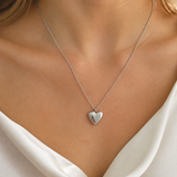 Model wearing Cora Heart Pendant in silver [finish:silver]