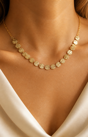 Model wearing Elara Medallion Necklace in gold [finish:gold]