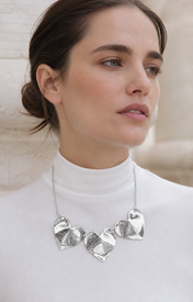 Model wearing Fiora Petal Necklace in silver [finish:silver]