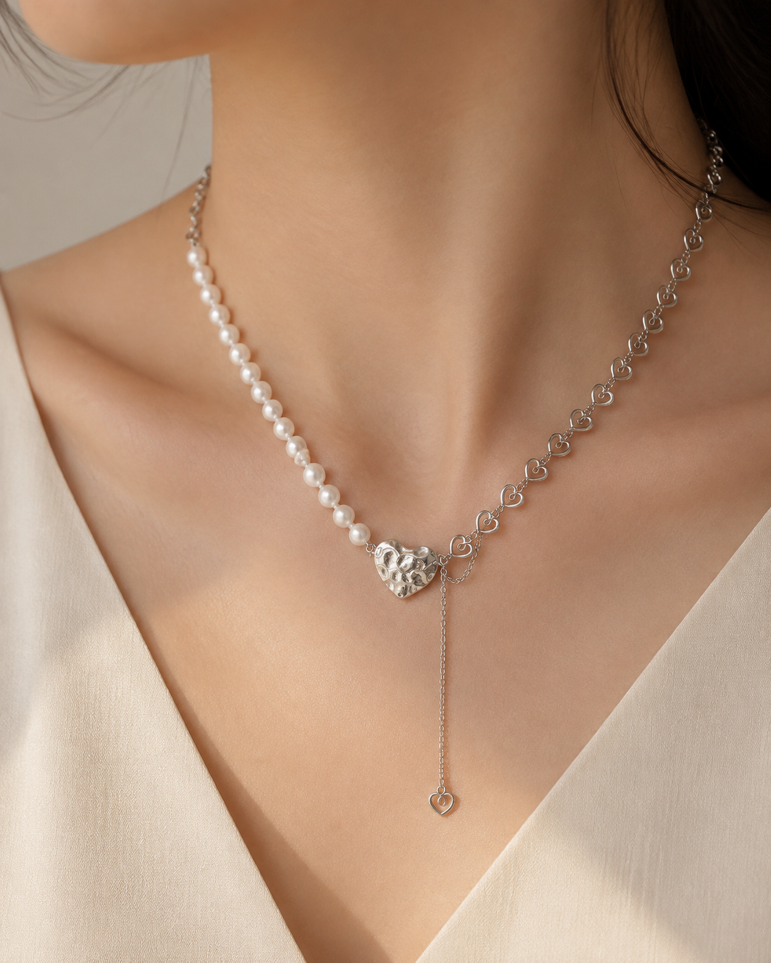 Model wearing Liora Pearl Heart Necklace — No. 11