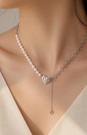 Model wearing Liora Pearl Heart Necklace — No. 11