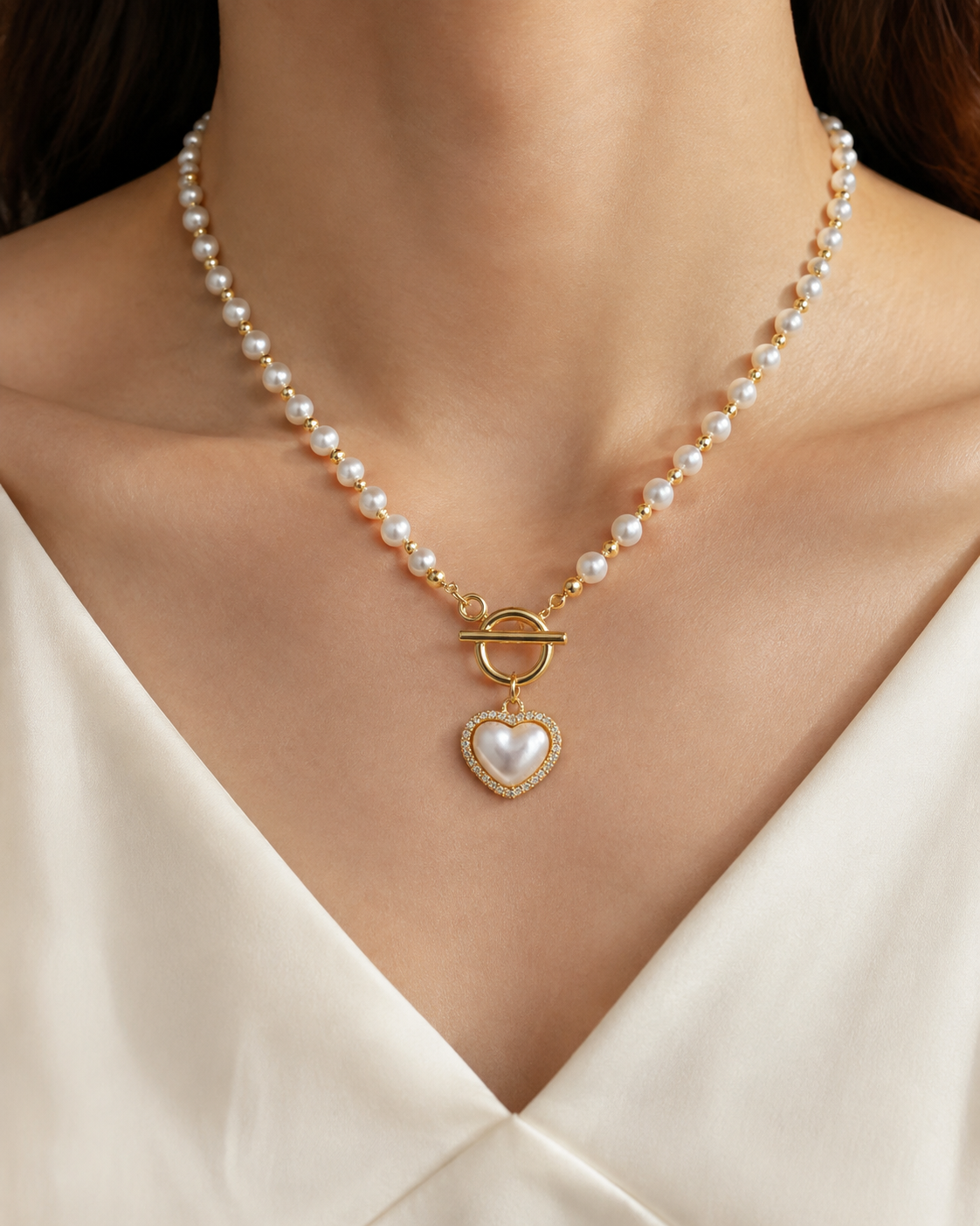 Model wearing Liora Pearl Heart Necklace — No. 12