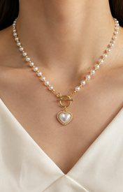Model wearing Liora Pearl Heart Necklace — No. 12