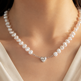 Model wearing Liora Pearl Heart Necklace — No. 13