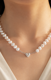 Model wearing Liora Pearl Heart Necklace — No. 13