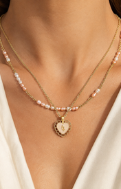 Model wearing Amara Pearl Heart Necklace