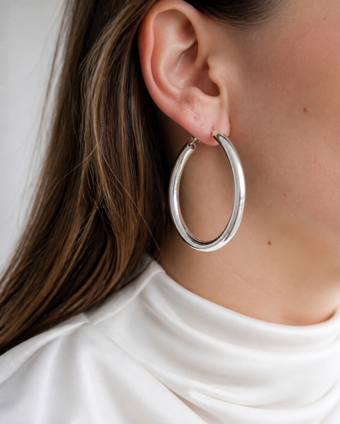 Model wearing Evara Statement Hoops in silver