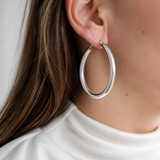 Model wearing Evara Statement Hoops in silver [finish:silver]