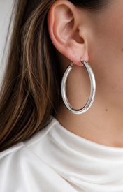 Model wearing Evara Statement Hoops in silver [finish:silver]