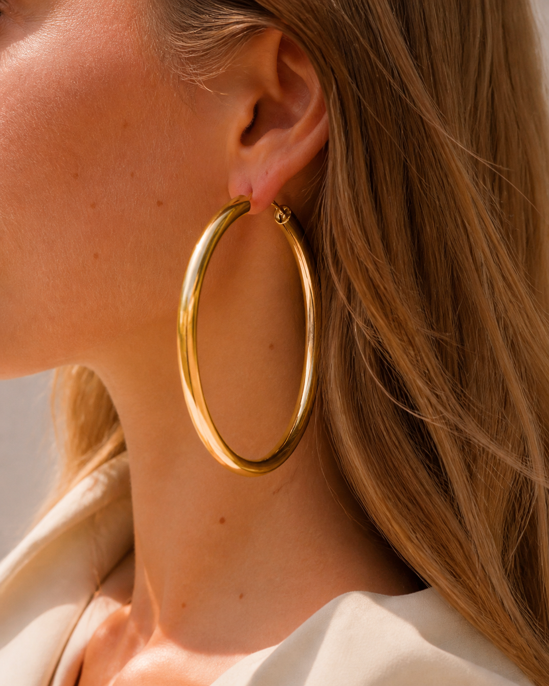 Model wearing Evara XL Hoops in gold