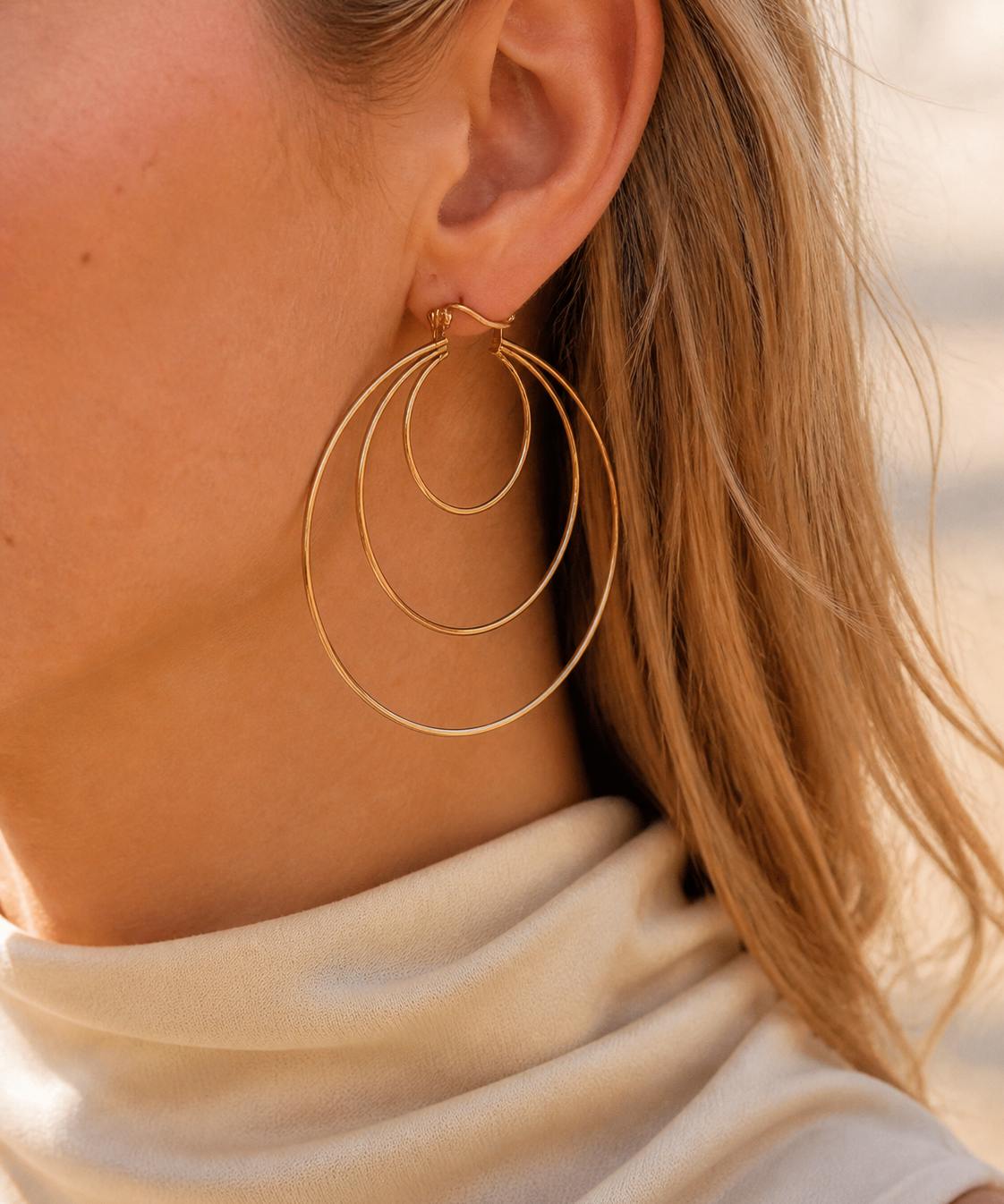Model wearing Aurea Spiral Earrings in gold [finish:gold]