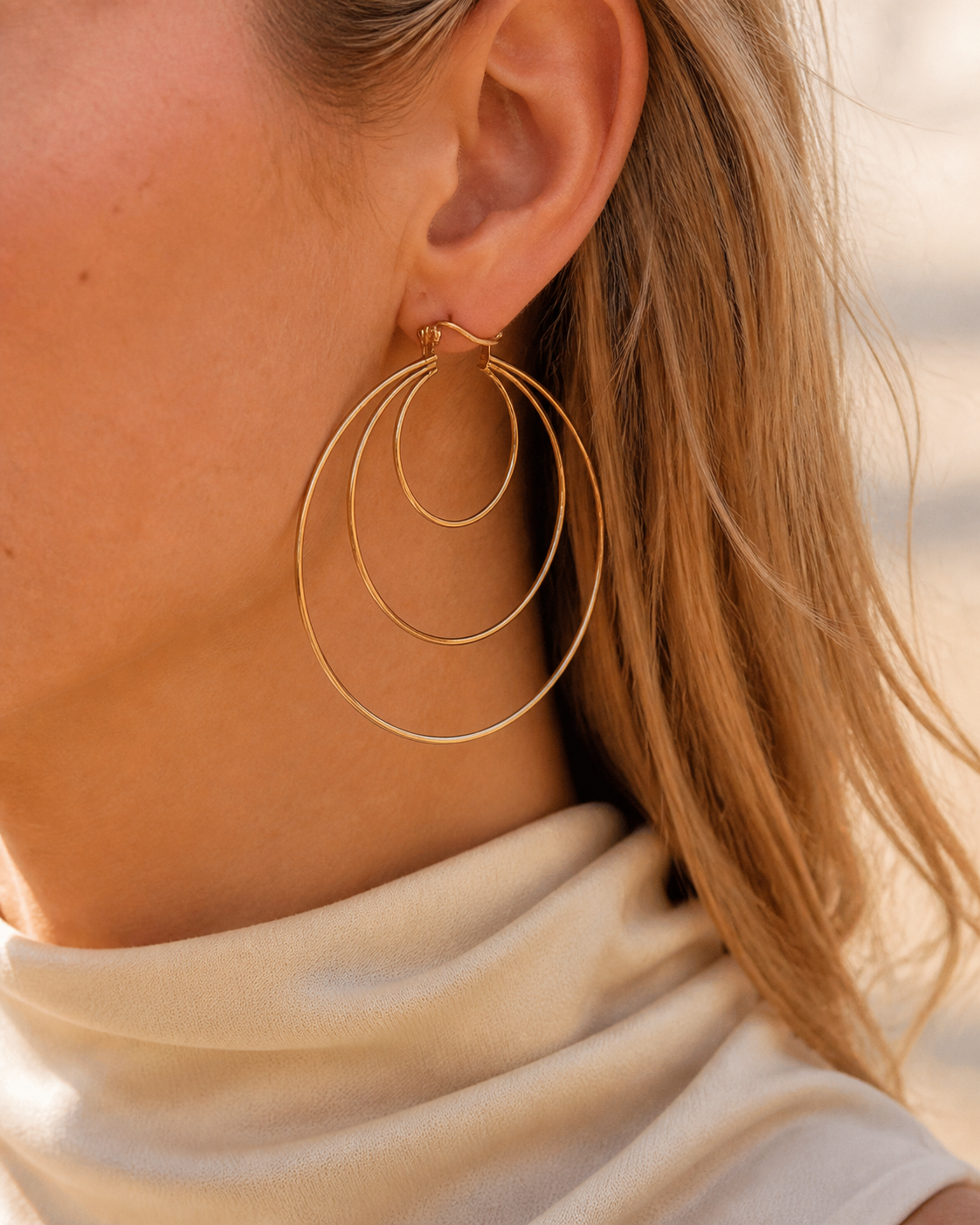 Model wearing Aurea Spiral Earrings in gold