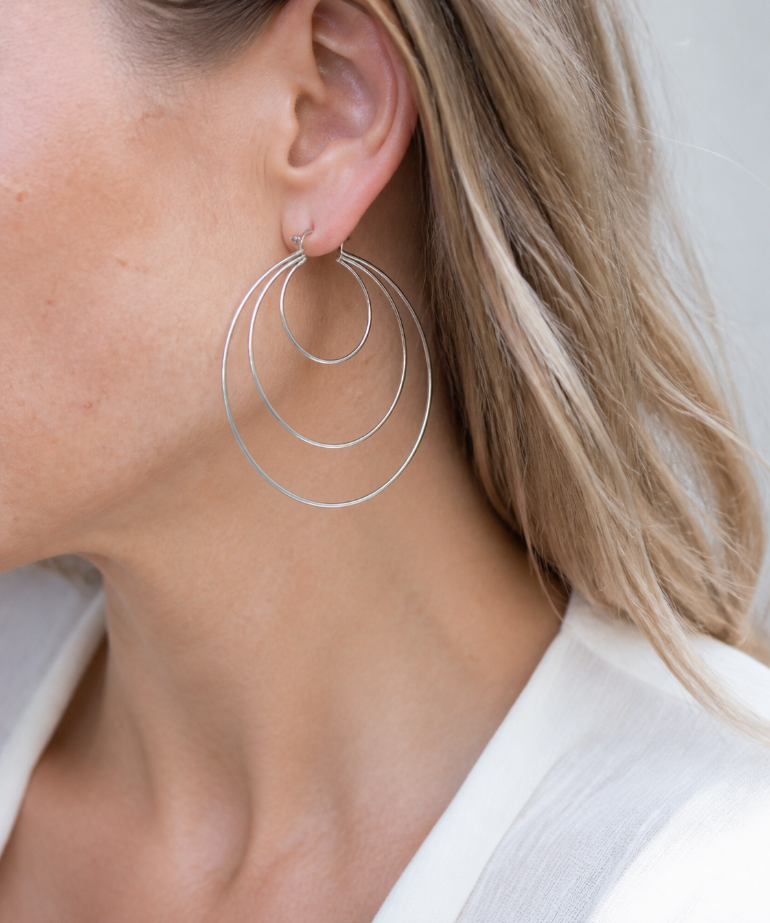 Model wearing Aurea Spiral Earrings in silver [finish:silver]