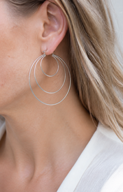 Model wearing Aurea Spiral Earrings in silver [finish:silver]