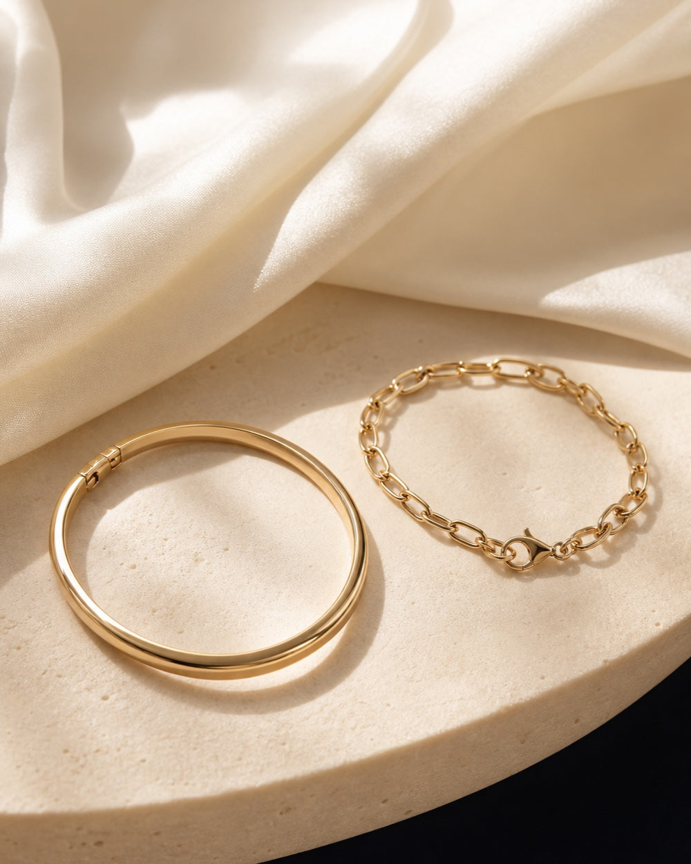 Gold bangle and link bracelet styled with ivory silk